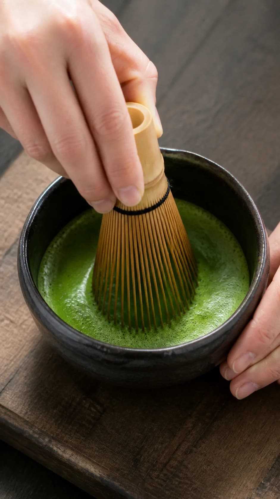 Matcha being whisked in a ceramic bowl